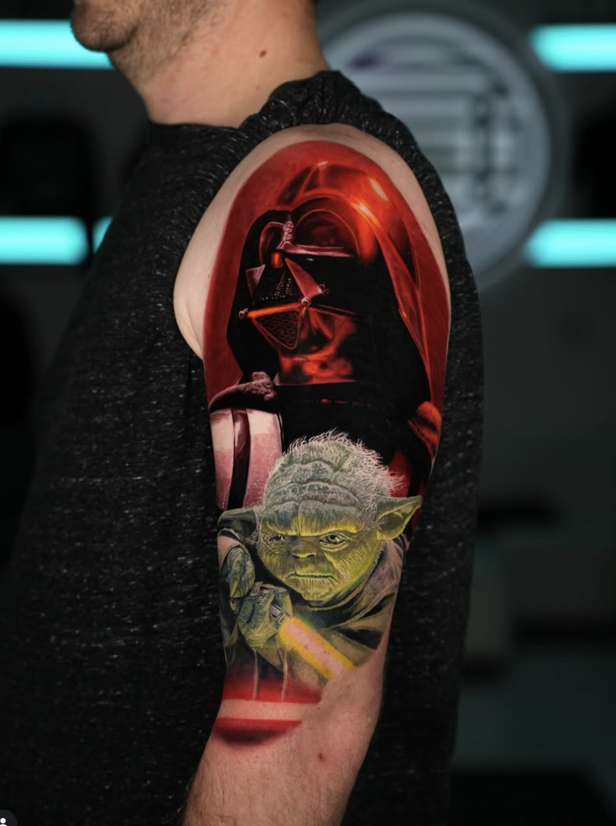 Colour realism upper arm piece of Darth Vader in red light above Yoda holding a glowing lightsaber